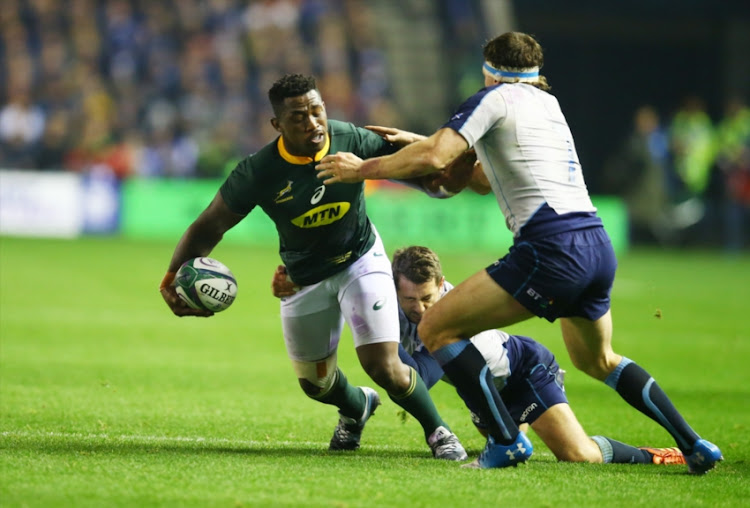 Siya Kolisi (captain) of South Africa tackled by Hamish Watson of Scotland during the Castle Lager Outgoing Tour match between Scotland and South Africa at BT Murrayfield on November 17, 2018 in Edinburgh, Scotland.