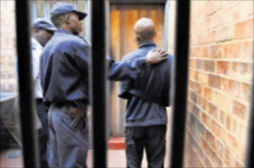 GOT YOU: Sergeant Vincent Nkuna with the suspect. The young man was arrested by Eldorado Park detectives on Tuesday. 16/04/09. Pic. Vathiswa Ruselo. © Sowetan.