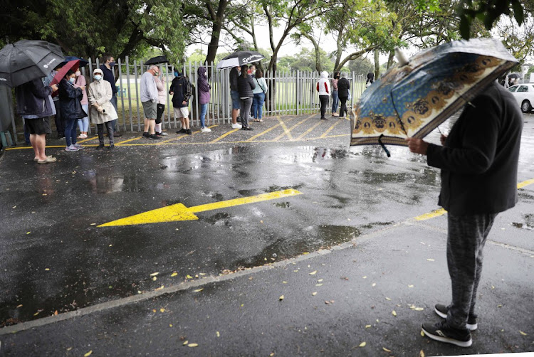 Voters queue in the rain to cast their local government votes in Pinelands, Cape Town, on November 1 2021.