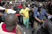 GIVE ME THE MIC: Julius Malema makes his way through the crowd to  address the crowd  protesting through the streets of Johannesburg last week PHOTO: HALDEN KROG