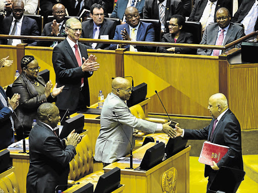 GLAD HAND: President Jacob Zuma congratulates Finance Minister Pravin Gordhan after his Budget speech last week.