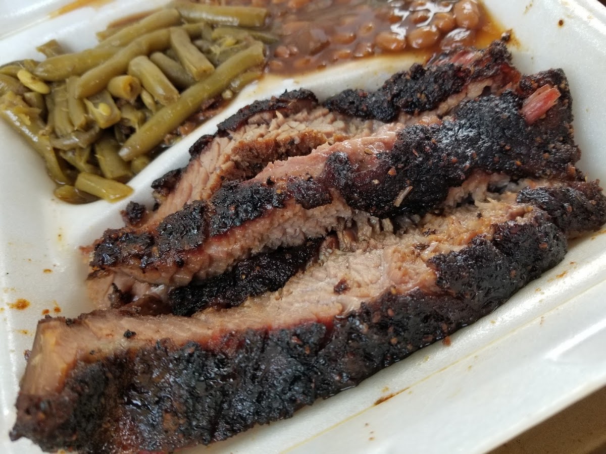 Brisket platter with green beans and baked beans. Brisket is a must get!