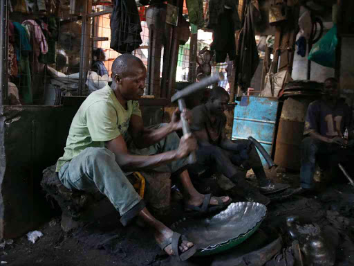 George Onyango with fellow jua kali artisans at his Kamukunji workshop, Nairobi, on July 19 /JACK OWUOR