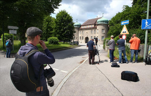 Journalists wait on June 2, 2014 in front of the prison in Landsberg am Lech, southern Germany, where Uli Hoeness, former president of German first division football club Bayern Munich, is serving time for tax evasion. KARL-JOSEF HILDENBRAND / DPA / AFP