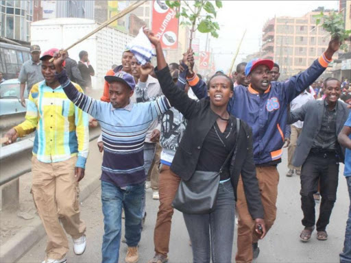 Protesting hawkers walk along the streets of Eastleigh on September 2, 2016 following the destruction of their stalls. /ENOS TECHE