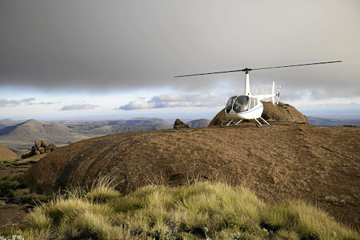 One of Fly Karoo's Robinson helicopters in the heart of the Great Karoo overlooking the Sneeuberg.