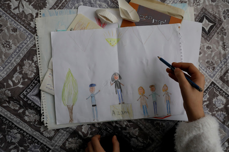 Azam Jangravi's daughter draws a picture which shows her mother during a protest, at the unknown location, February 7, 2019.