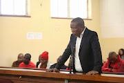 EFF leader Julius Malema stands in the dock in The Newcastle Magistrates court where he faces criminal charges relating to alleged contravention of the Riotous Assemblies Act.