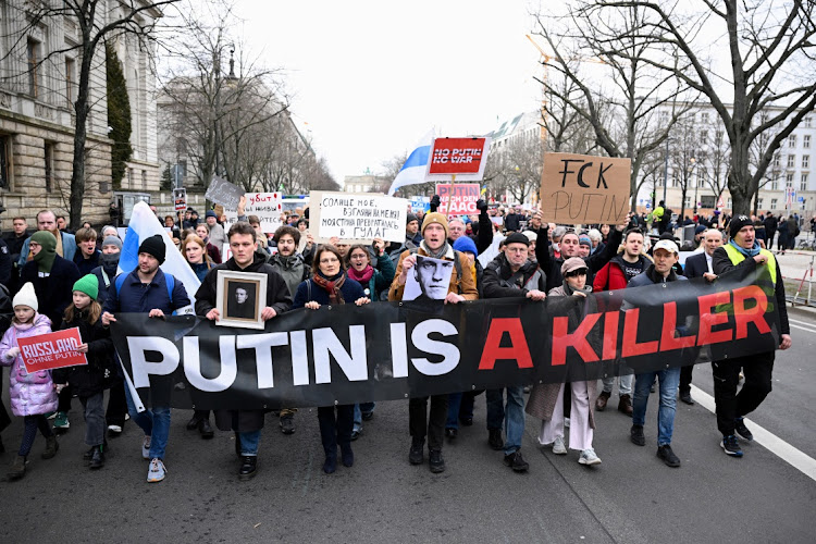 People hold a banner as they attend a rally held near the Russian embassy following the death of Russian opposition leader Alexei Navalny, in Berlin, Germany, February 18 2024. Picture: ANNEGRET HILSE/REUTERS