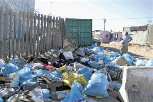 NO WAY TO LIVE: Kosovo informal settlement community leader Apheus Ndima stands in front of rubbish left behind on Friday by city employees. PHOTO: UNATHI OBOSE