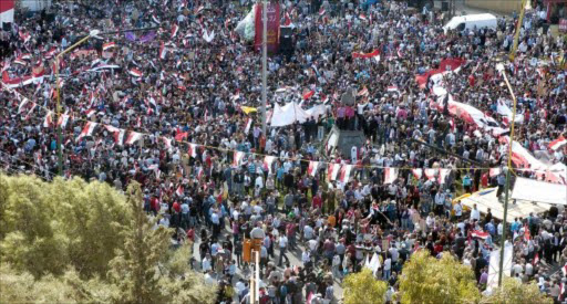 A handout picture released by the Syrian Arab News Agency (SANA) shows Syrians rallying in support of President Bashar al-Assad in the city of Sweida, south of Damascus, on October 30, 2011.