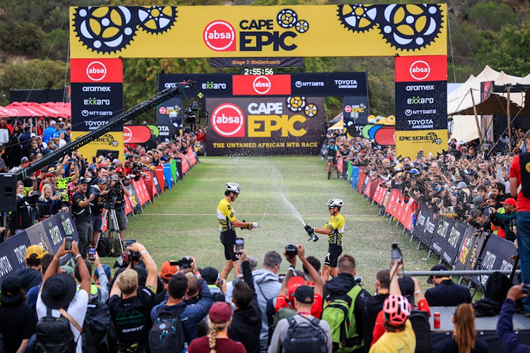 SA’s Matthew Beers, left, and Toyota-Specialised-NinetyOne partner Howard Grotts of the US celebrate their overall victory in the 2024 Absa Cape Epic at the finish at the Coetzenburg Athletics Stadium in Stellenbosch on Sunday. Picture: ABSA CAPE EPICX