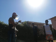 Unemployed graduates Talent Gaxa and Jabulo Khanyile huddle with their friends in Umlazi smoking dagga, still contemplating whether they will vote.