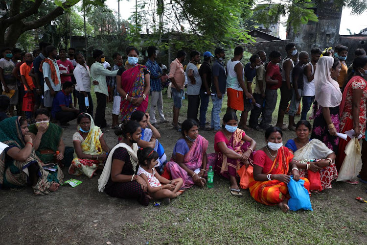 People wait in a queue to receive a dose of COVISHIELD vaccine, manufactured by Serum Institute of India, outside a vaccination centre in Siliguri, in the eastern state of West Bengal, India, October 7 2021. Picture: REUTERS/RUPAK DE CHOWDHURI