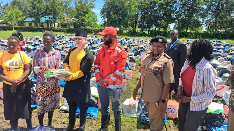 Government Spokesperson Isaac Mwauru and Kenya Red Cross Secretary General Idris Ahmed during distribution of non-food items to displaced families at Nduru, Kabonyo Kanyagwal in Nyando, Kisumu county on May 7, 2024