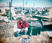 Fezeka Feni sits amongst the ruins of her former home in Kosovo informal settlement in Philippi after a fire in the area.  