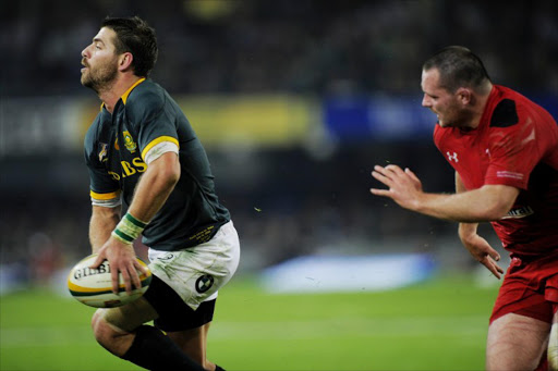 Wing Willie le Roux (L) gets ready to pass the ball during the Rugby test match between South Africa and Wales at Kings Stadium on June 14, 2014 in Durban, South Africa.