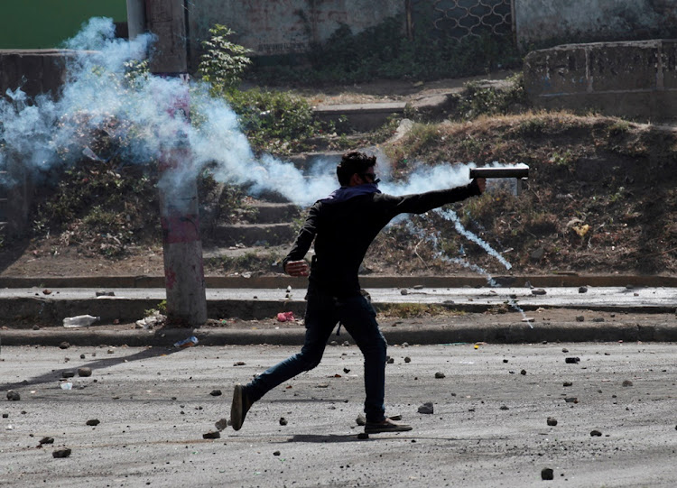 A demonstrator fires a homemade mortar towards riot police during a protest over a controversial reform to the pension plans of the Nicaraguan Social Security Institute in Managua, Nicaragua on April 21, 2018.