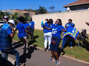 DA supporters create a festive atmosphere near Northwood Boys' High in Durban, where party leader John Steenhuisen will cast his vote.