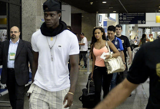 Italy's forward Mario Balotelli (2-L) arrives with his girlfriend Fanny Neguesha (C) at the airport in Fortaleza, Brazil, on June 24, 2013. It seems while Liverpool are focusing on turning their fortunes around on the pitch with a 2-1 FA Cup win over AFC Winbledon on 5 January 2015, their injured Italian striker Mario Balotelli has kept himself busy by courting girls on social media. JUAN BARRETO / AFP