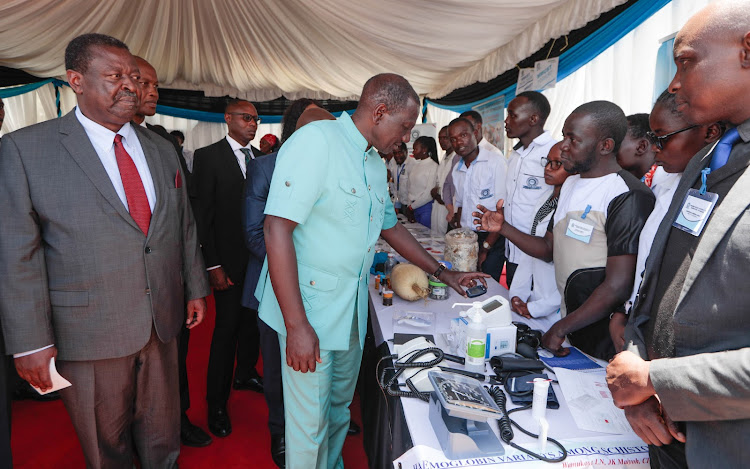 President William Ruto looking at health equipment at Masinde Muliro University during the Kakamega County International Investment Conference on March 20, 2024
