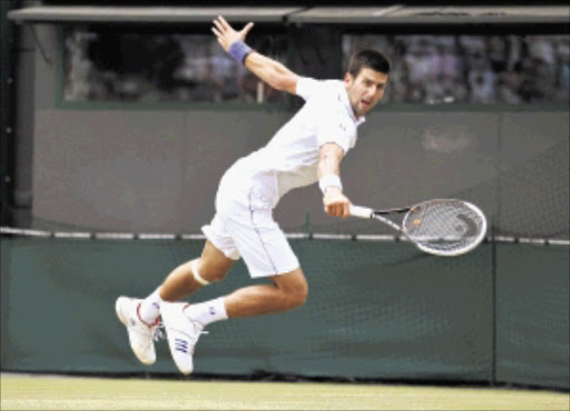 Novak Djokovic of Serbia hits a return to Bernard Tomic of Australia during their quarterfinal at the Wimbledon tennis championships in London yesterday. Djokovic won in straight sets to set up a semifinal clash against Jo-Wilfried Tsonga, who defeated Roger Federer Picture: STEFAN WERMUTH/GALLO IMAGES