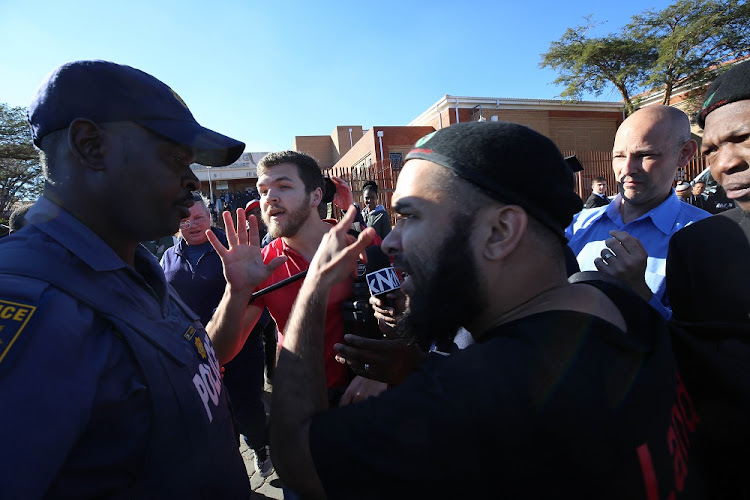 Journalists and members of the Black First Land First (BLF) clash outside the Randburg Magistrate's Court in Johannesburg after Duduzane Zuma's an appearance. He is facing charges of culpable homicide linked to a 2014 collision between his Porsche and a minibus taxi.