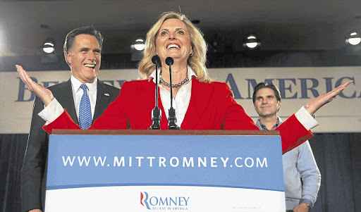 COMMON TOUCH: Republican hopeful Mitt Romney looks on as his wife, Ann, addresses supporters Picture: REUTERS