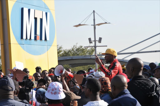 MTN staff members protest outside the headquarters on 14th Avenue on May 20, 2015 in Johannesburg, South Africa. Members of the Communication Workers Union have downed tools to embark on wage increase protest. Picture Credit: Gallo Images