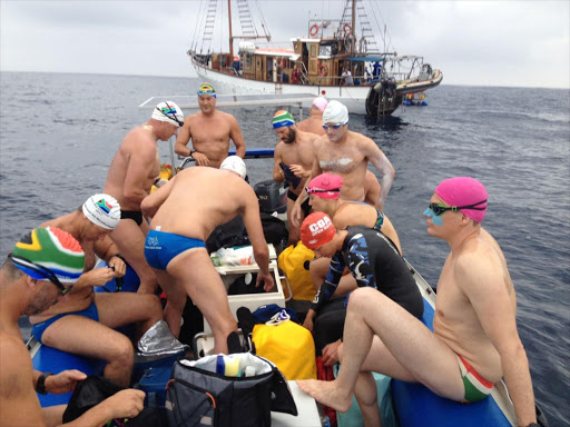 Some of the swimmers about to jump off a rubber duck just before the start, with the Wildoceans support vessel Angra Pequena in the background. Picture: SUPPLIED