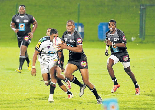 FULL STEAM: Luzuko Mafu from the WSU All Blacks runs with the ball while Athenkosi Ndzenene follows up in support during their match against the UKZN Impi at the BCM Stadium last night Picture: SINO MAJANGAZA