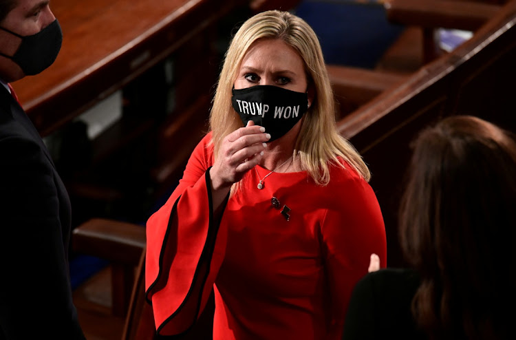 U.S. Rep. Marjorie Taylor Greene (R-GA) wears a "Trump Won" face mask as she arrives on the floor of the House to take her oath of office.
