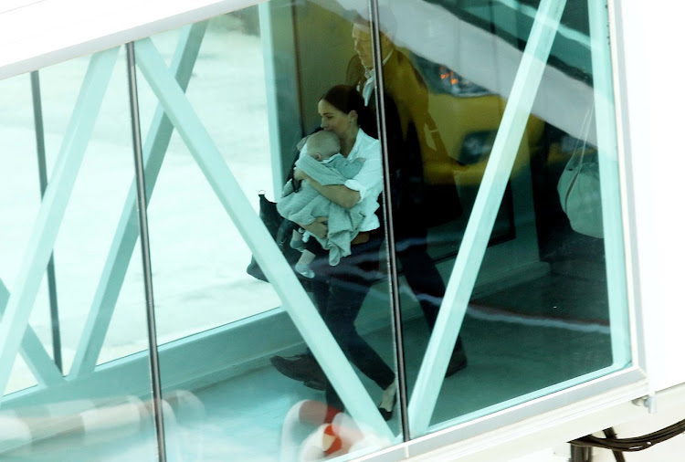 Meghan Markle and her baby son, Archie, cross an airbridge at Cape Town International Airport on September 28 2019, on their way on to a scheduled British Airways flight to Johannesburg.