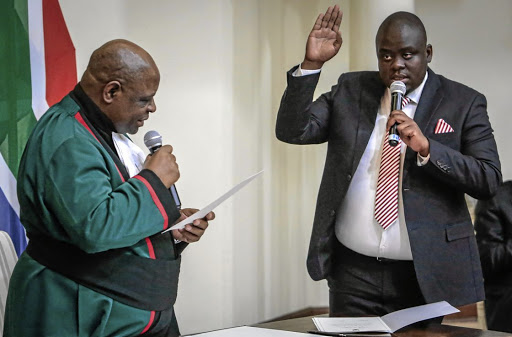 Deputy minister of home affairs Njabulo Nzuza is sworn in by deputy chief justice Raymond Zondo.