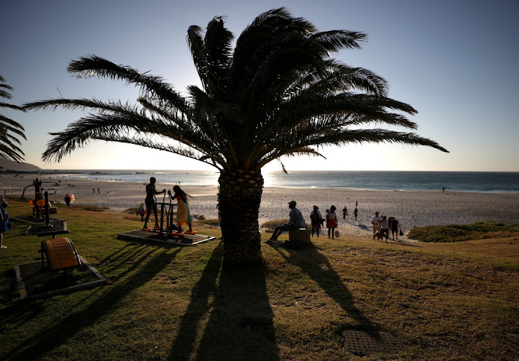 Visitors at Camps Bay beach in Cape Town. Western Cape premier Alan Winde has called for an end to the national state of disaster. File photo.