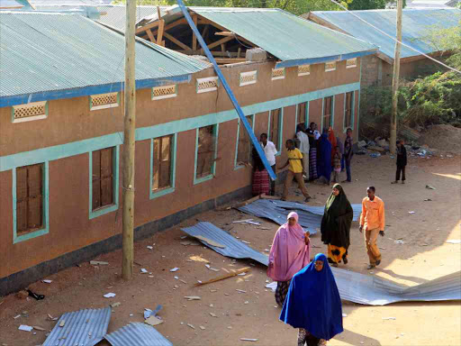 Residents look at the damaged Bishaaro Lodge attacked by al Shabaab in Mandera on October 25 /REUTERS