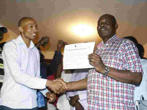 Governor Ranguma receiving a ticket from deputy returning officer despite coming second in Kisumu county. PHOTO/COURTESY