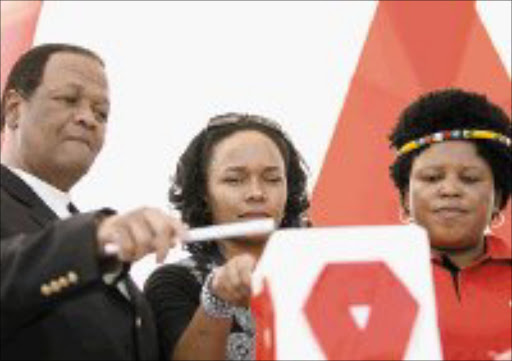 BRAVE FACE: HIV positive Siphokazi Redman, 34, flanked by acting Minister of Health Jeff Radebe and MEC for health in KwaZulu-Natal Peggy Nkonyeni speaks at the international candlelight ceremony in Durban yesterday. Pic. Mandla Mkhize. © Sowetan.