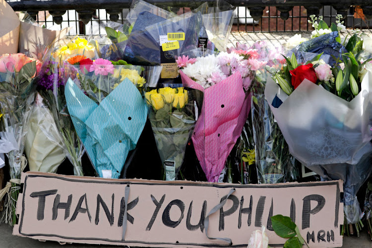 Floral tributes to the late Prince Philip are seen at Buckingham Palace in London on April 9 2021. The British government has asked the public not to gather or leave tributes at royal residences in light of Covid-19.