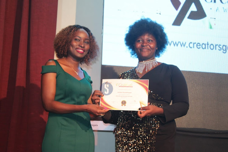 Badili Africa Director Bina Maseno awards a certificate to diversity and inclusion advocate winner Getrude Nthambi during the Inaugural Content Creator Awards ceremony at the National Museums, Nairobi on April 4, 2024