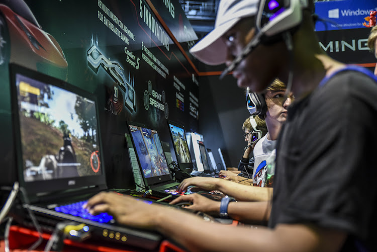 An attendee of the Rage gaming Expo at the TicketPro Dome, Johannesburg enjoys one of the many games and gaming culture stands on show.
