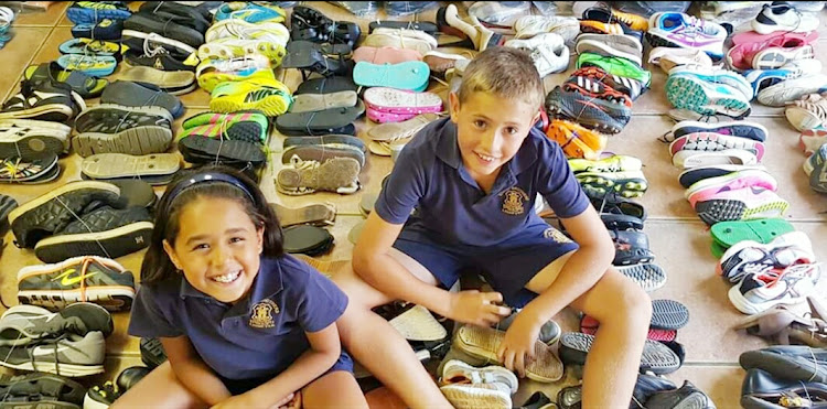 Dario Gouveia and his sister, Liana, sort through hundreds of pairs of donated shoes.
