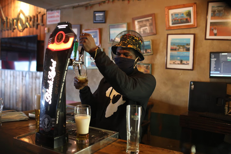 A bartender in Melville, Johannesburg, wears a mask while pouring beer during eased lockdown restrictions. Less than 2,000 new cases of Covid-19 were again reported across SA on Wednesday.
