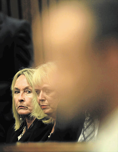 FACE-OFF: June Steenkamp, the mother of Reeva Steenkamp, left, looks at Oscar Pistorius as he sits in the dock in the Pretoria High Court