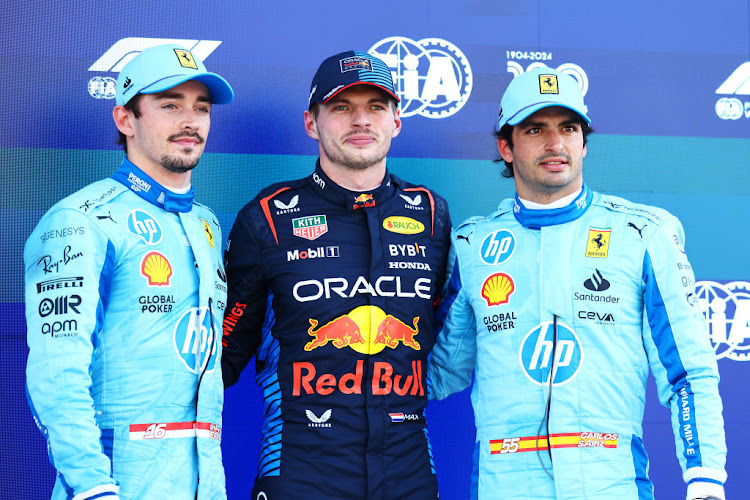Verstappen (centre) was joined on the front row by Ferarri's Charles Leclerc (left). Carlos Sainz (right) will start third alongside the second Red Bull of Sergio Perez.
