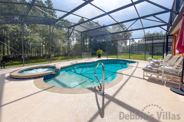 Sun-drenched pool deck with scenic view at this Watersong vacation villa 