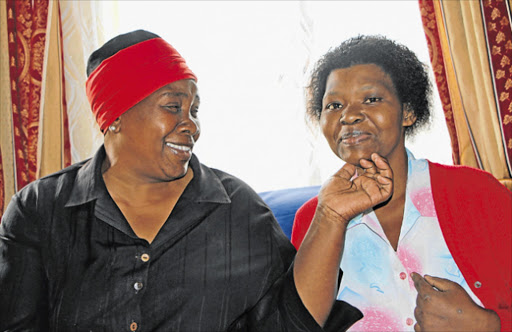 RECOVERED: Smiles and laughter as Luleka Ndamase, a listeriosis survivor, is back to full health. She sits with her stepmother Lindiwe in their Duncan Village home Picture: NONSINDISO QWABE