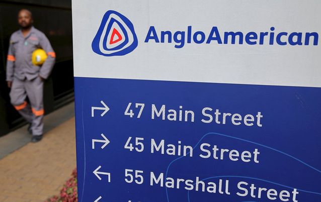 A worker walks past a board outside Anglo American offices in Johannesburg. Picture: REUTERS/SIPHIWE SIBEKO