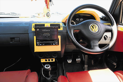 INSIDER INFO: The dashboard and VW logo on the steering wheel are trimmed in yellow, as is the Jensen DVD player