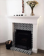 The Circled Flower ceramic tile makes an ideal decorative touch in this fireplace.